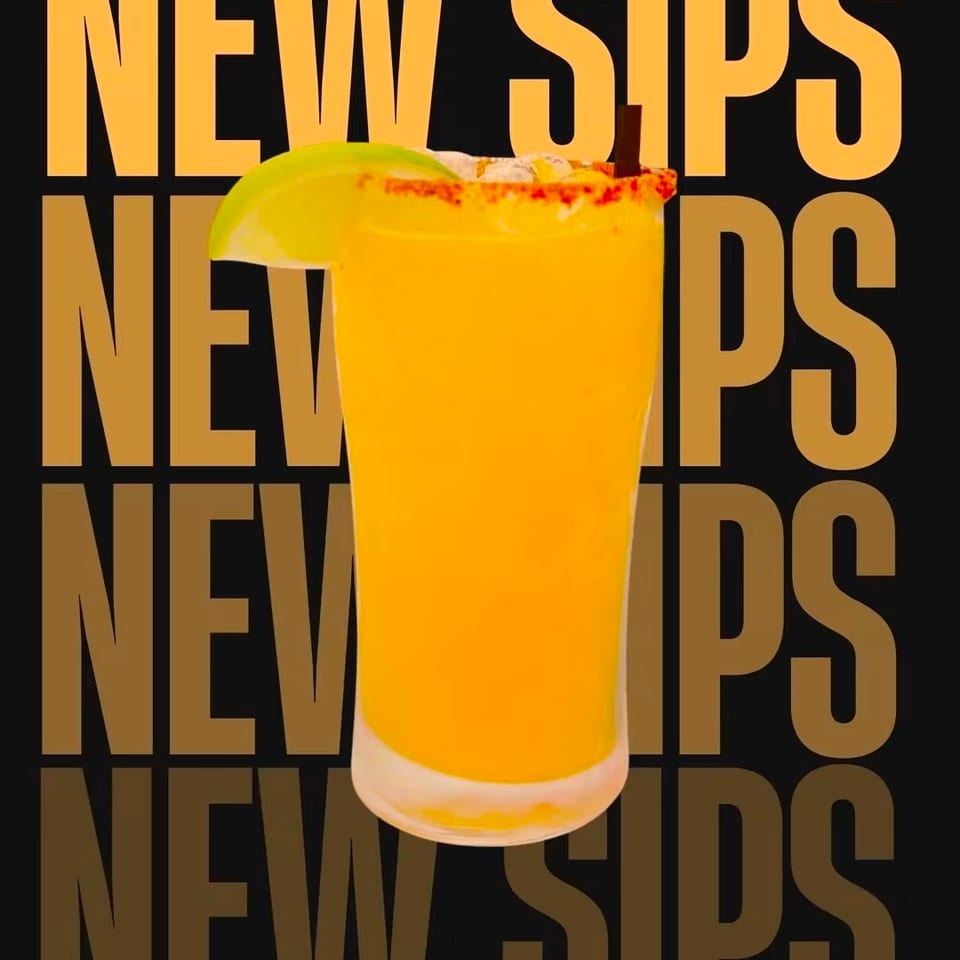 Bright orange cocktail in a glass garnished with a lime wedge and chili-salt rim, against a bold repeating “NEW SIPS” background.